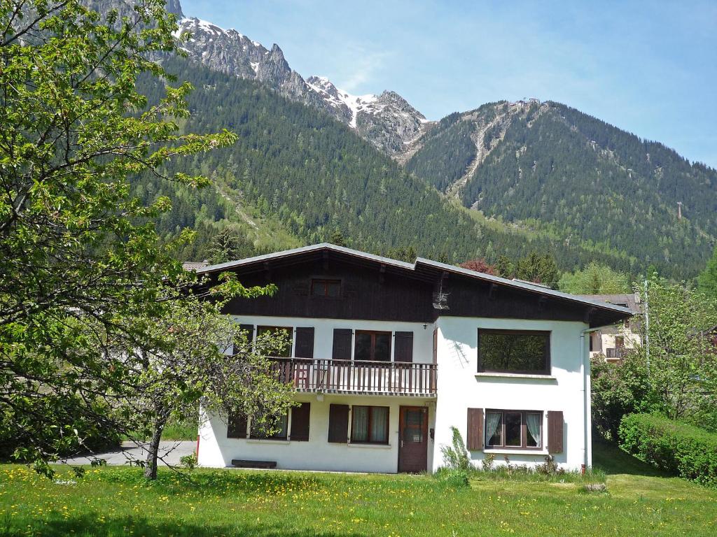 a white house with a balcony in front of a mountain at Apartment Maison Novel by Interhome in Chamonix-Mont-Blanc