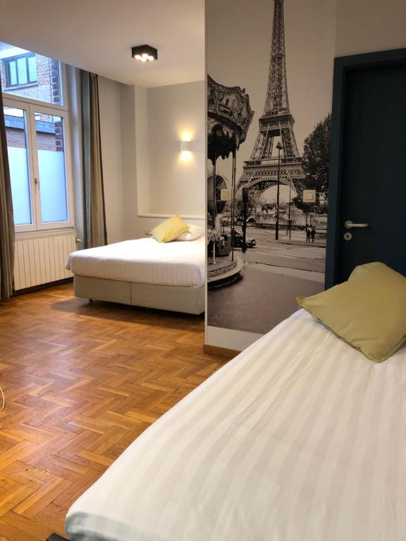En eller flere senge i et værelse på Hotel Le Cygne d'Argent