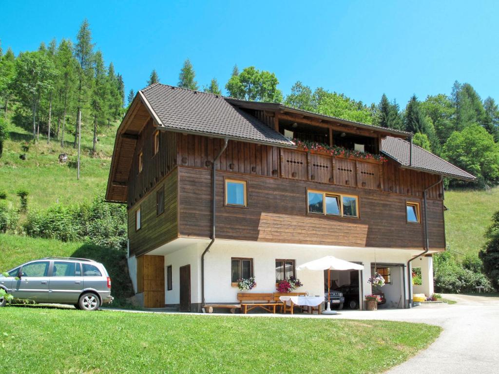 a house with a car parked in front of it at Apartment Herzele by Interhome in Arriach