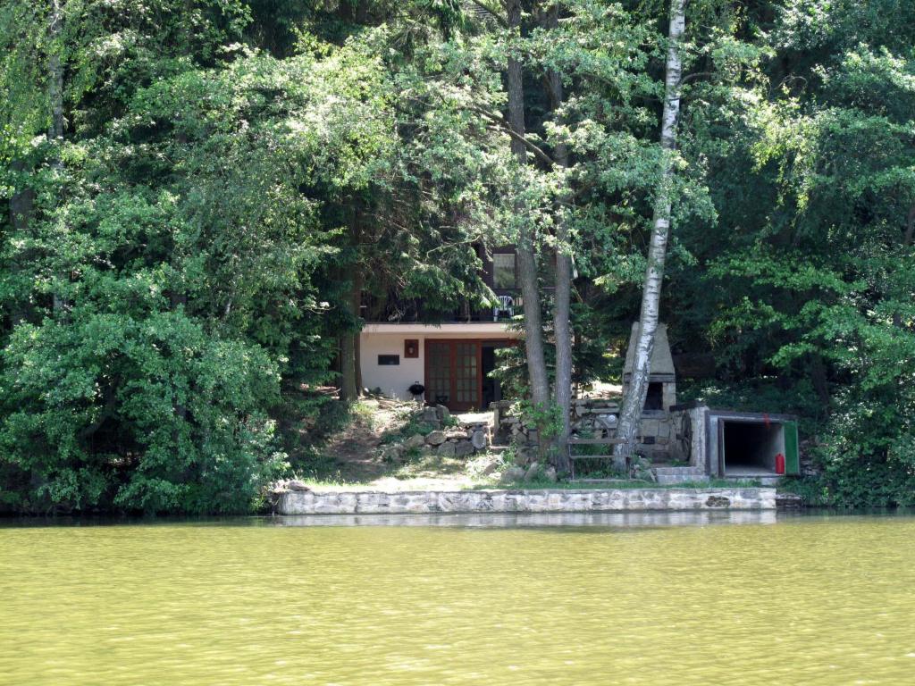 a house sitting on the shore of a lake at Chalet Bily - SZV100 by Interhome in Střížovice
