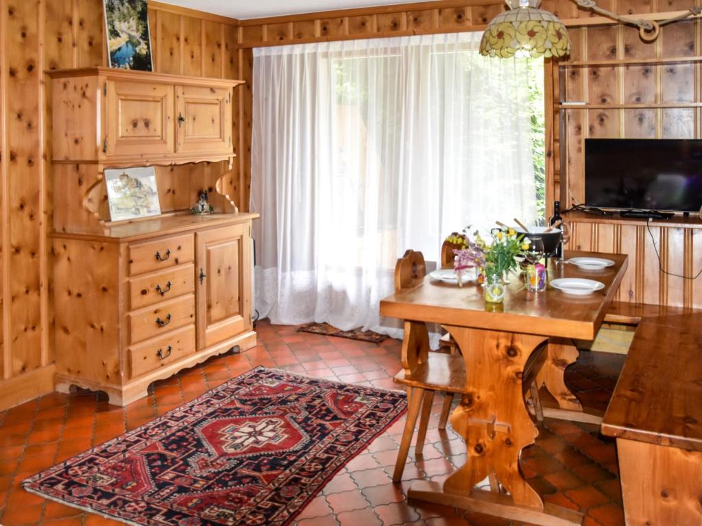 a living room with a wooden table and a window at Apartment Talisman 7 by Interhome in Verbier