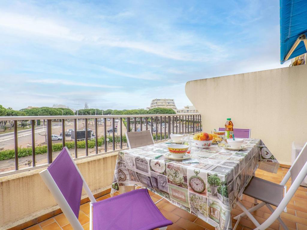 a balcony with a table and chairs on a balcony at Apartment Les Jardins du Port-4 by Interhome in Le Grau-du-Roi