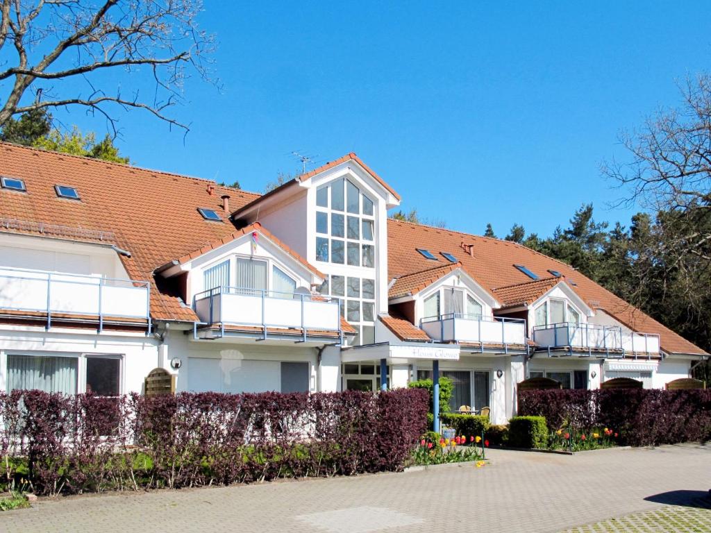 a large white house with a red roof at Apartment Glowe - GLW655 by Interhome in Glowe