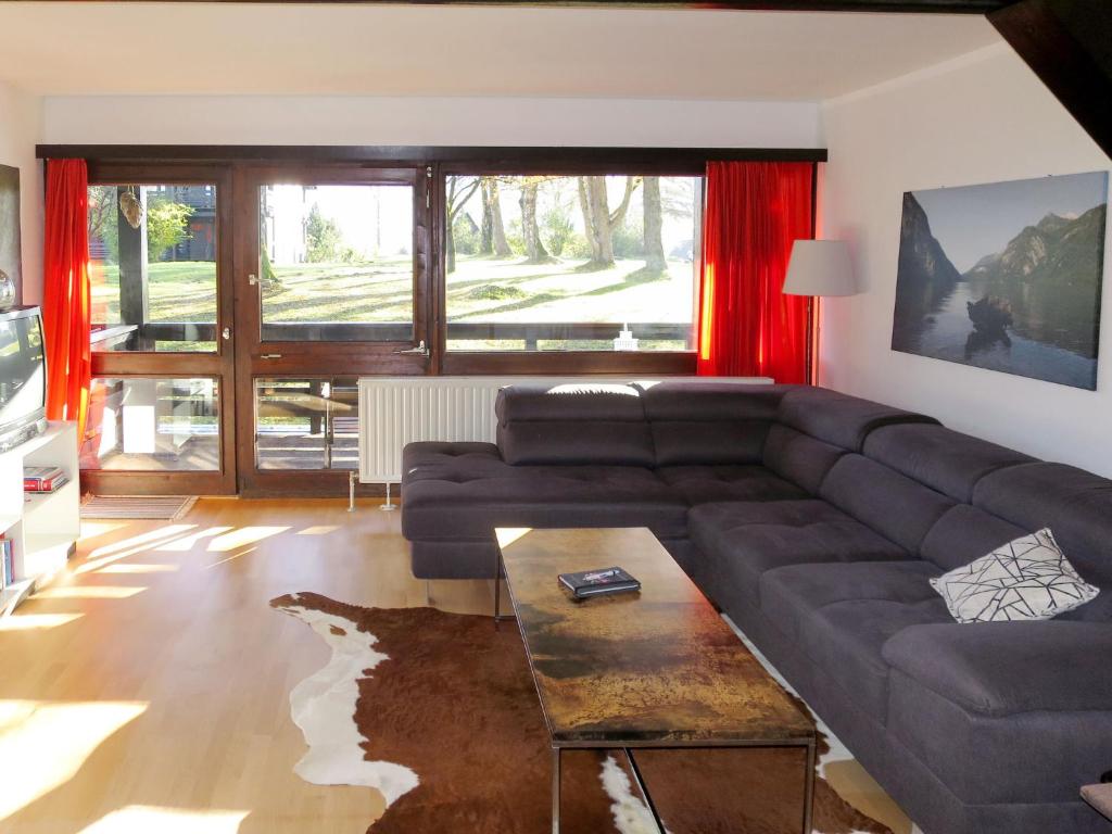 a living room with a couch and a table at Apartment Siegsdorf by Interhome in Siegsdorf