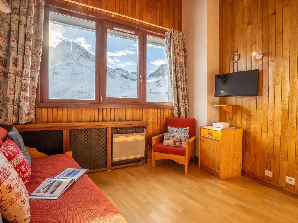 a living room with a couch and a window at Apartment Le Curling B-21 by Interhome in Tignes