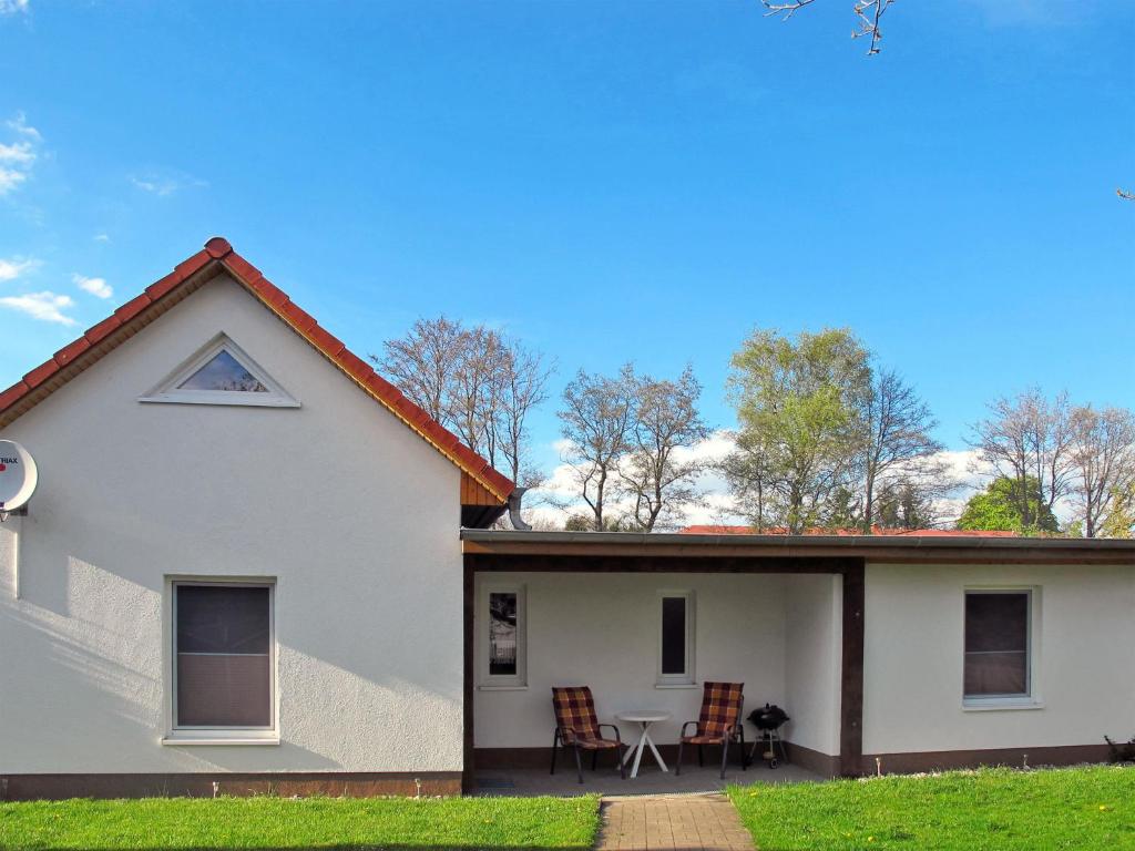 a white house with a table and chairs at Holiday Home Ella by Interhome in Zinnowitz