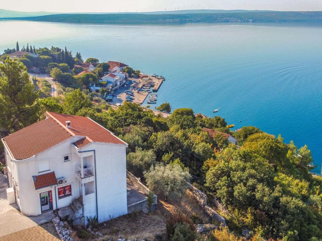 an image of a house on a hill next to the water at Apartment Mirjana by Interhome in Maslenica