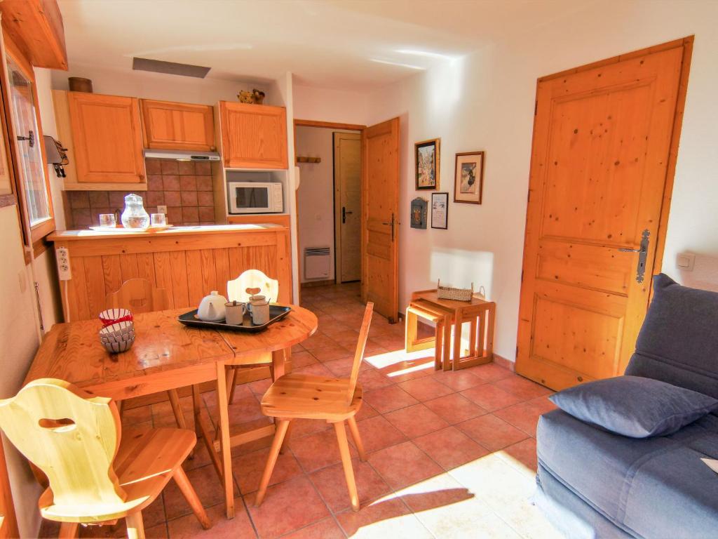 a kitchen and living room with a table and chairs at Apartment L'Espace Montagne-5 by Interhome in Chamonix