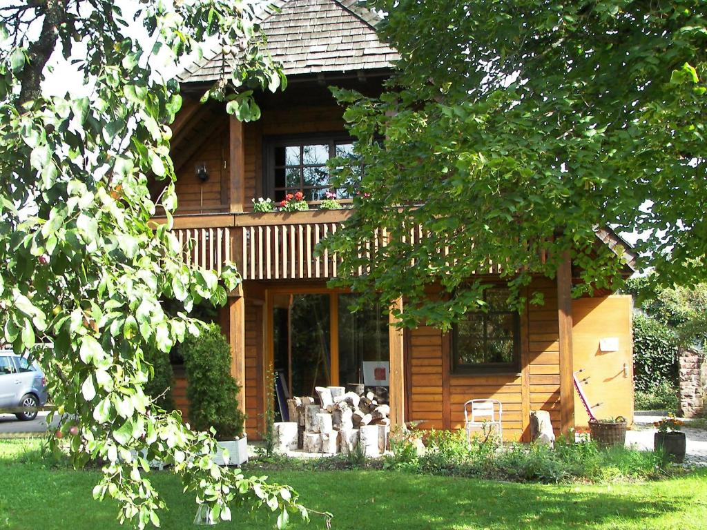 a log cabin with a car parked in front of it at Apartment Albergo Natura by Interhome in Hüfingen