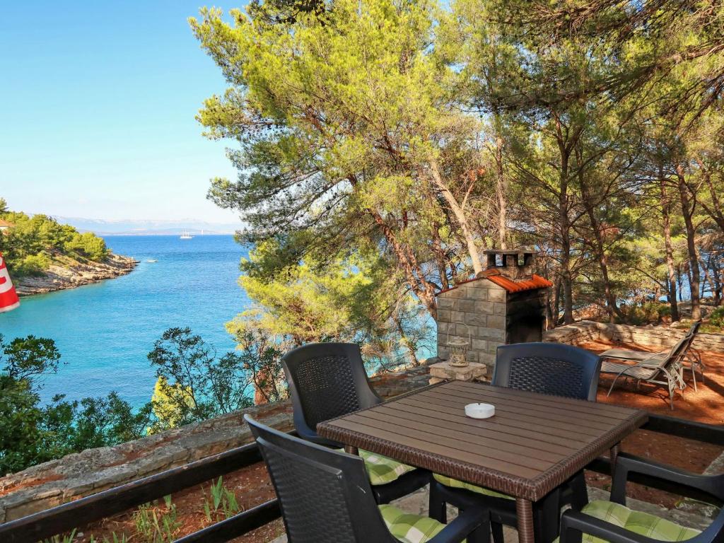 a table and chairs on a balcony with a view of the ocean at Holiday Home Neli - ISO305 by Interhome in Rogač