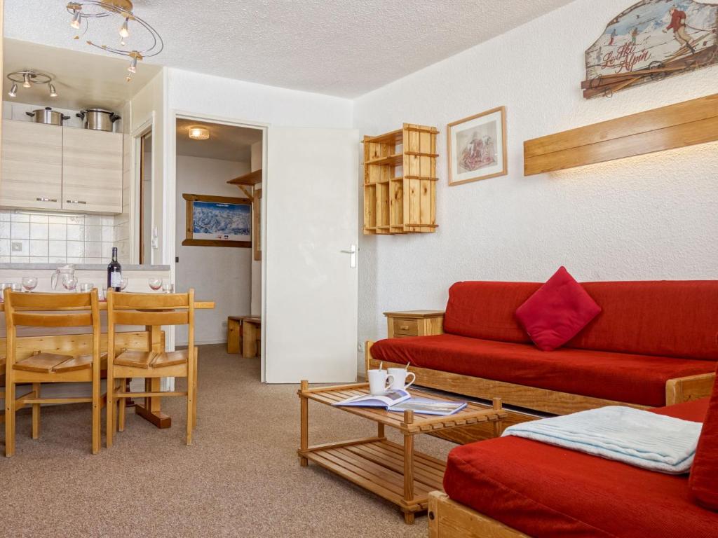 un salon avec un canapé rouge et une table dans l'établissement Apartment Les Tommeuses - Val Claret-24 by Interhome, à Tignes