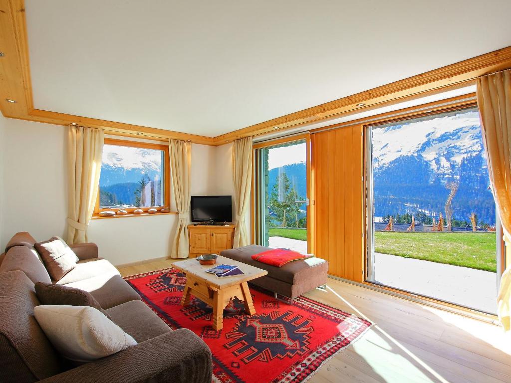 a living room with a couch and a table at Apartment Chesa Sül Muot by Interhome in St. Moritz