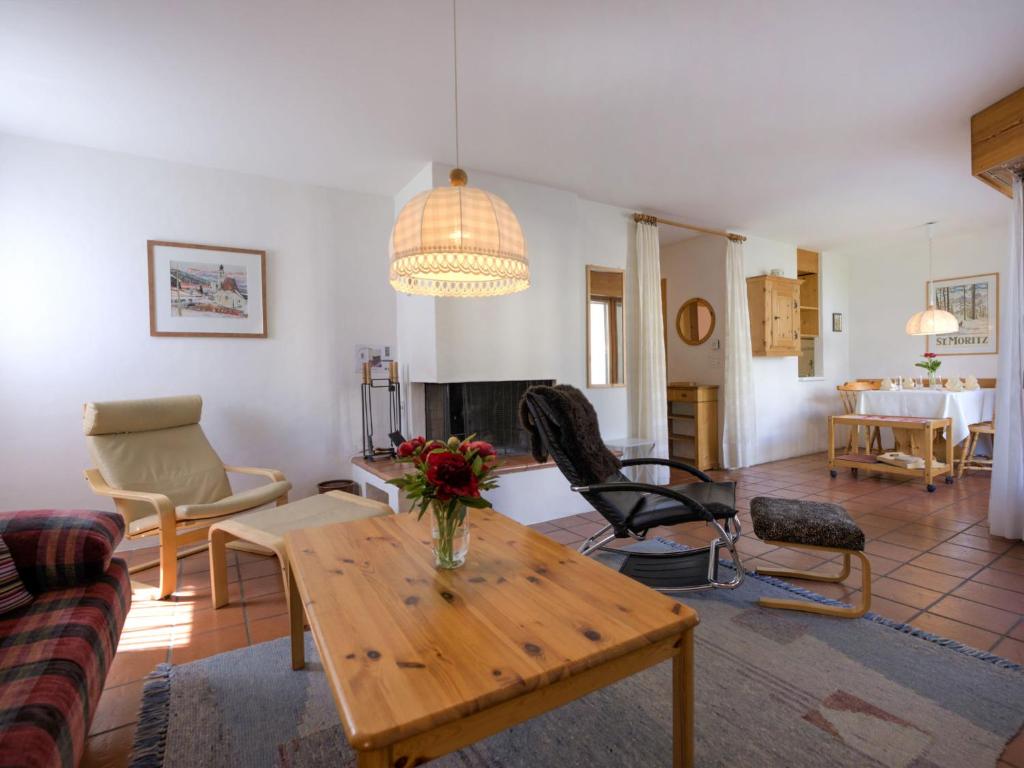 a living room with a table and chairs at Apartment Chesa Maurus A1 by Interhome in St. Moritz
