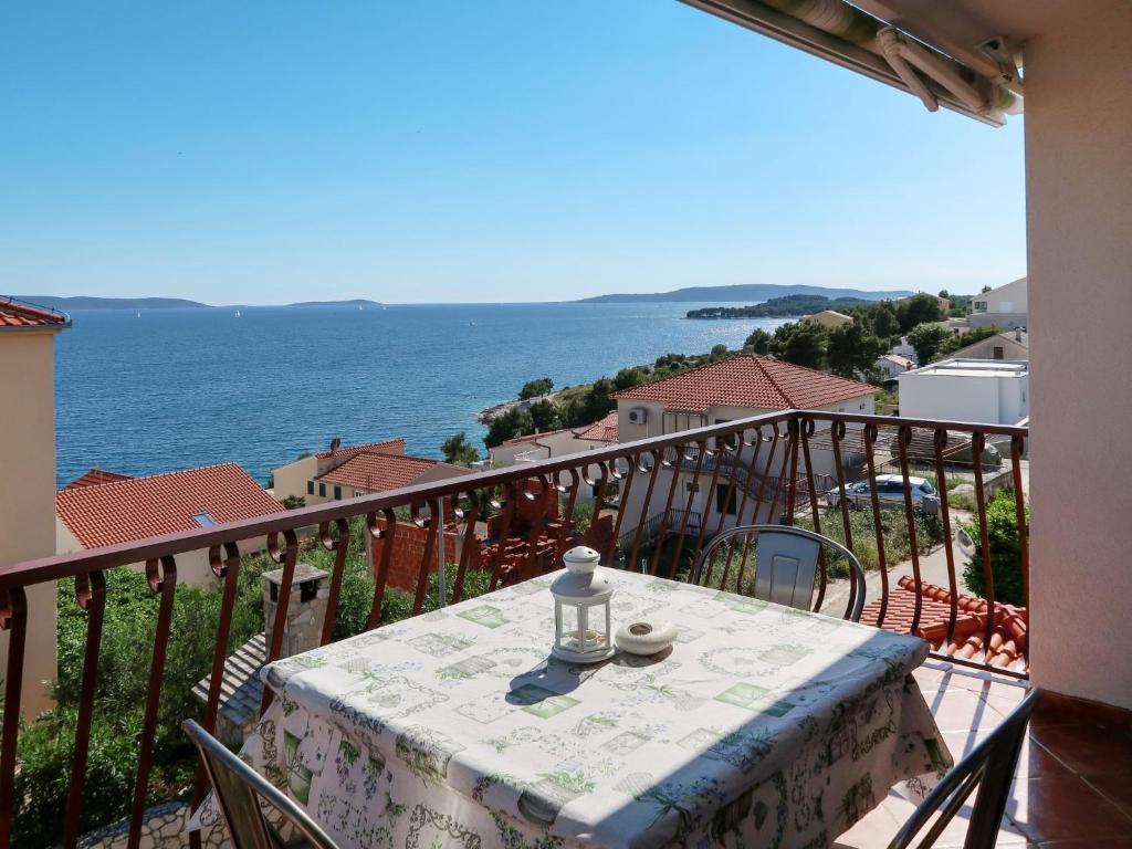 a table on a balcony with a view of the ocean at Apartment Culić-2 by Interhome in Trogir