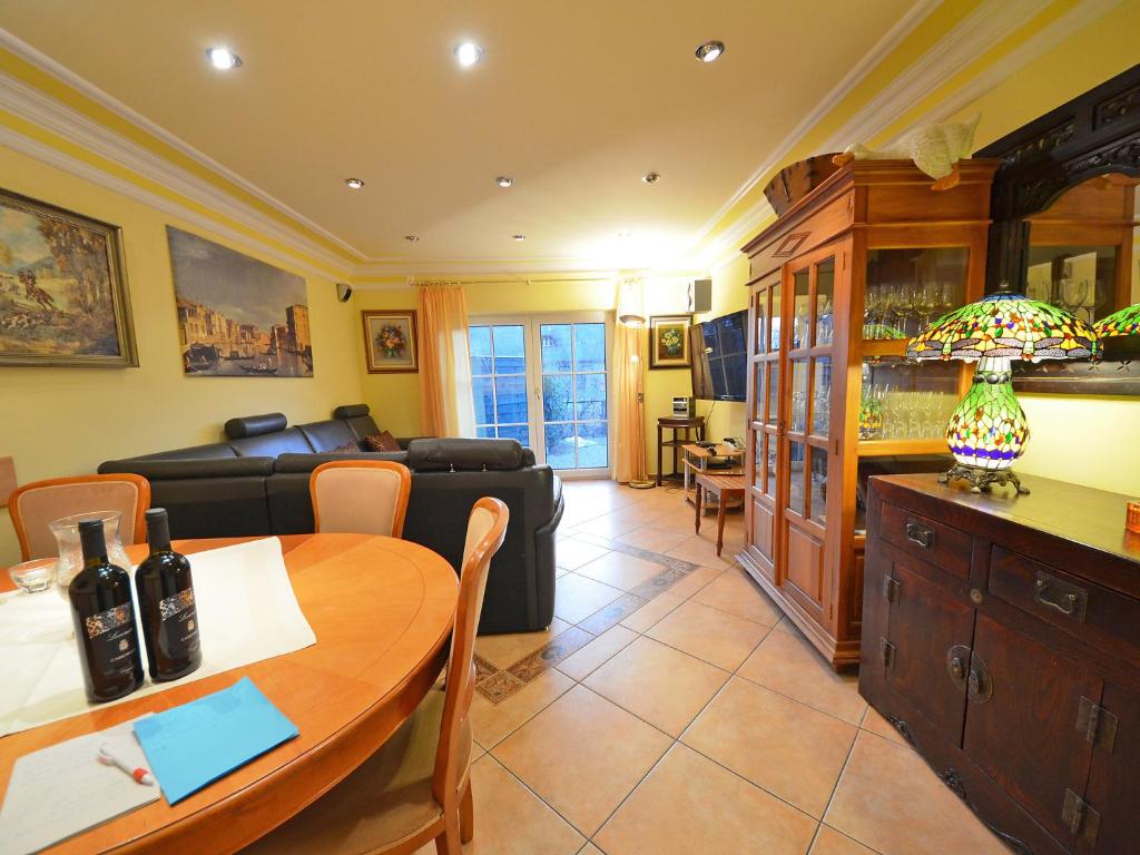 a living room with a table and a couch at Holiday Home Dünenrose by Interhome in Groß Zicker