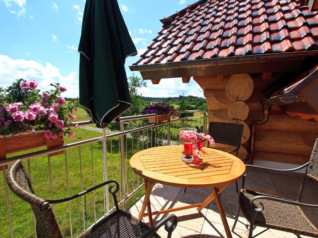 a table and chairs on a balcony with a gazebo at Apartment Ahorn by Interhome in Schönbronn