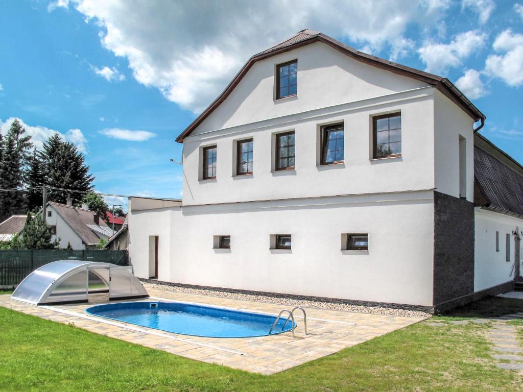a house with a swimming pool in front of it at Holiday Home IVA - OVH100 by Interhome in Olešnice v Orlických horách