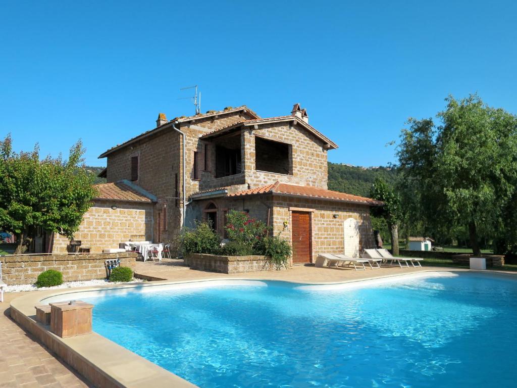 a house with a swimming pool in front of a building at Apartment Casa Ricardo n- 4 by Interhome in Montefiascone