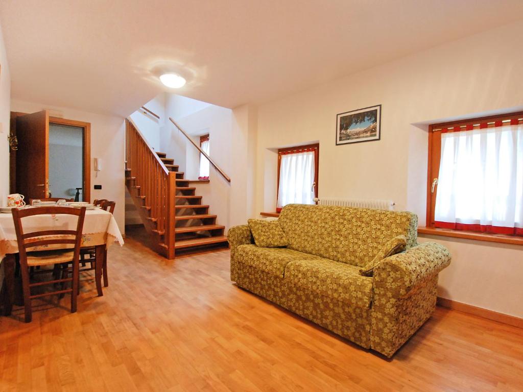 a living room with a couch and a table at Apartment Albergo Diffuso - Cjasa Fantin by Interhome in Barcis
