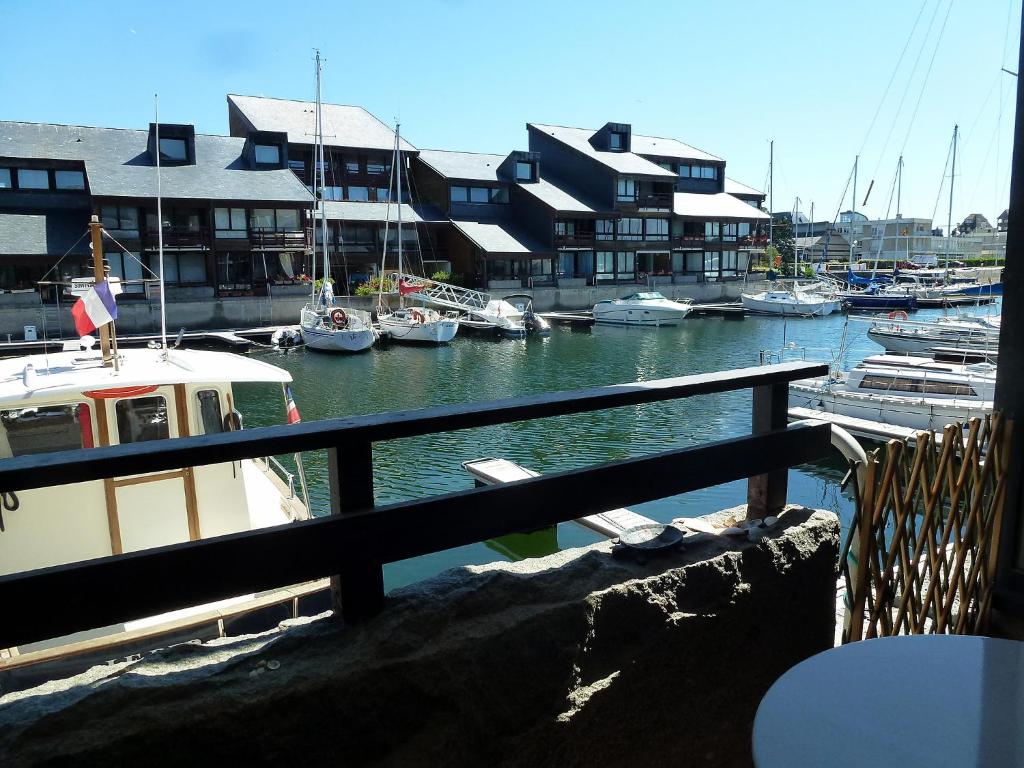 a boat is docked in a marina with other boats at Apartment Les Marinas-7 by Interhome in Deauville