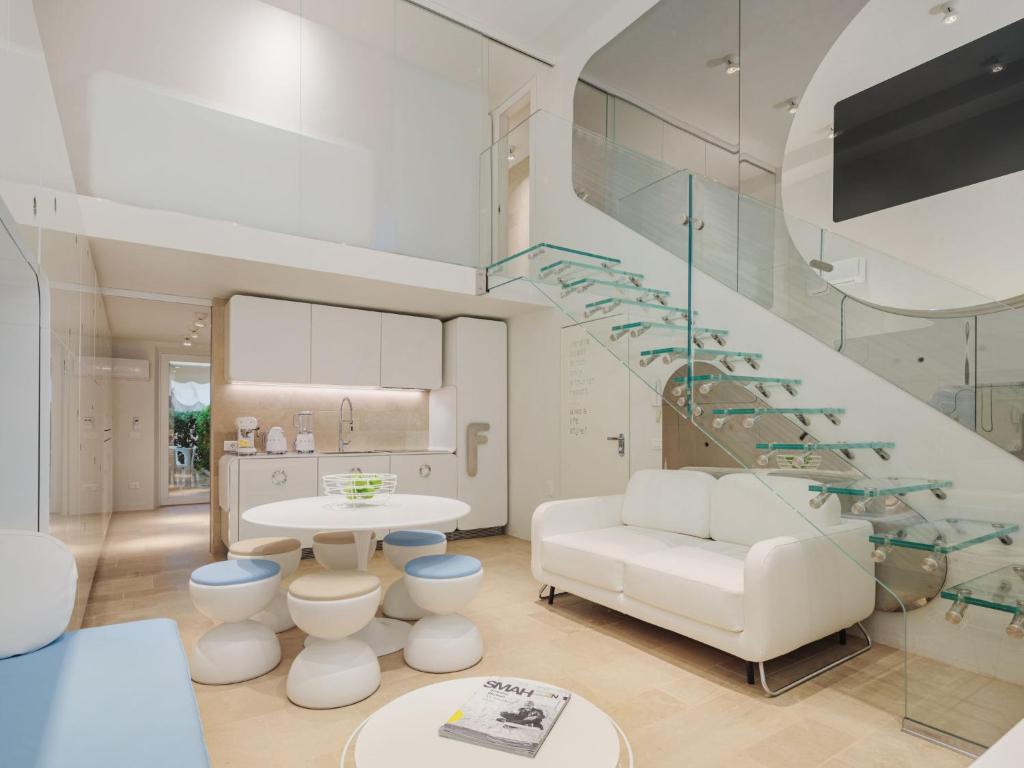 sala de estar con escalera y sofá blanco en Apartment Sea Design Home by Interhome en Viareggio