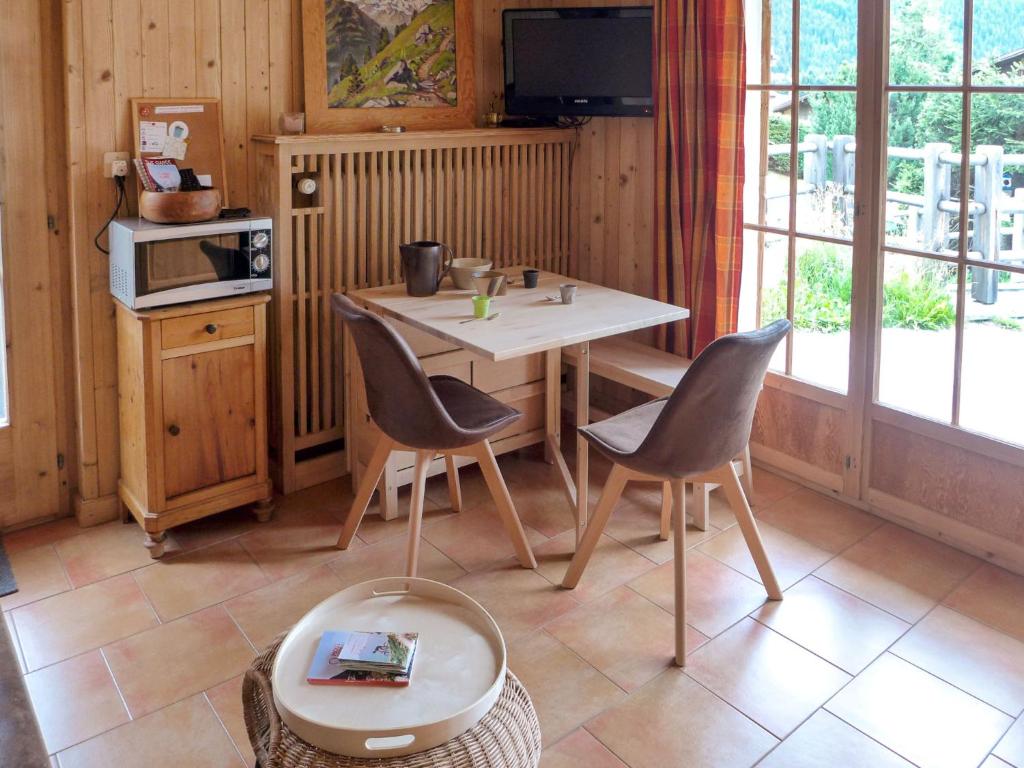 a kitchen with a table and chairs and a tv at Apartment Fury by Interhome in Verbier