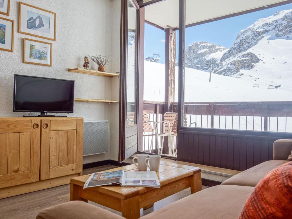 a living room with a tv and a large window at Studio Les Tommeuses - Val Claret-27 by Interhome in Tignes