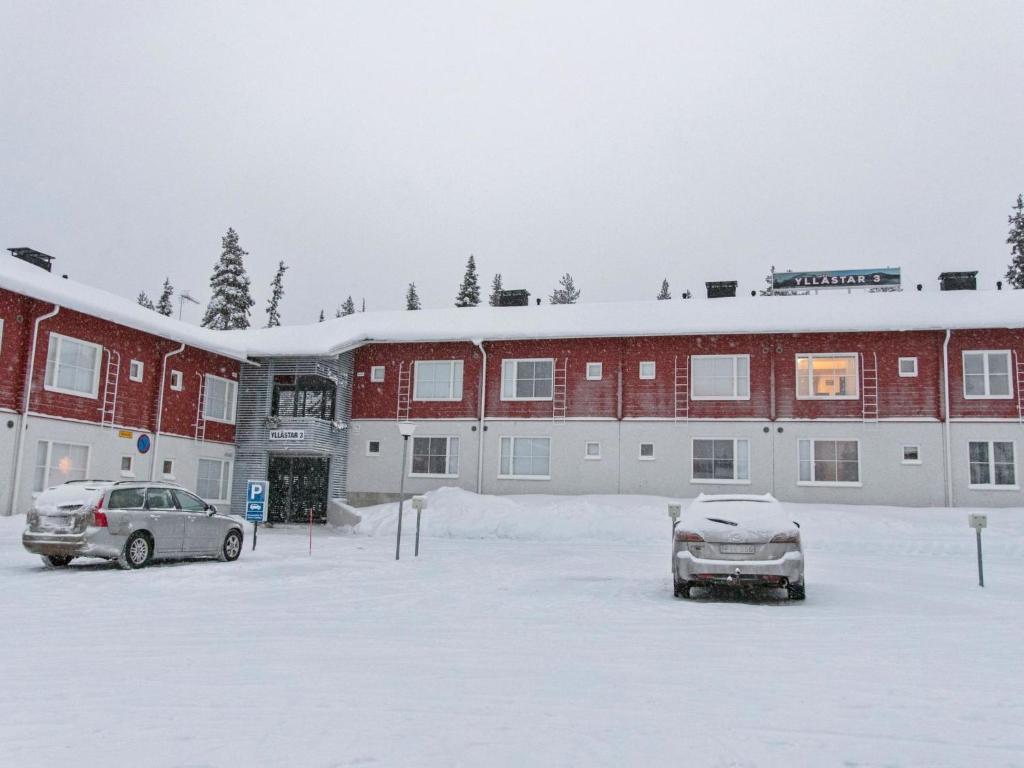 a snow covered parking lot in front of a building at Holiday Home Yllästar 3 as 509 by Interhome in Äkäslompolo