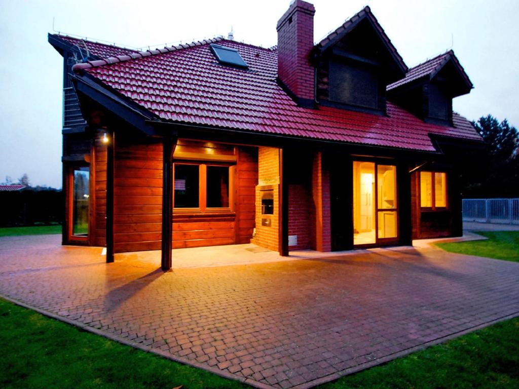 a house with a brick driveway in front of it at Holiday Home Drewniany z bala by Interhome in Dębki