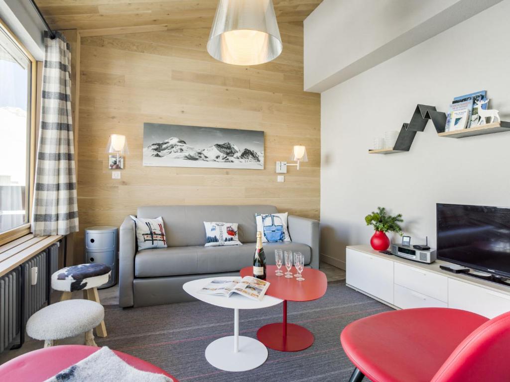 a living room with a couch and a table at Apartment Les Hauts du Val Claret - Val Claret-21 by Interhome in Tignes
