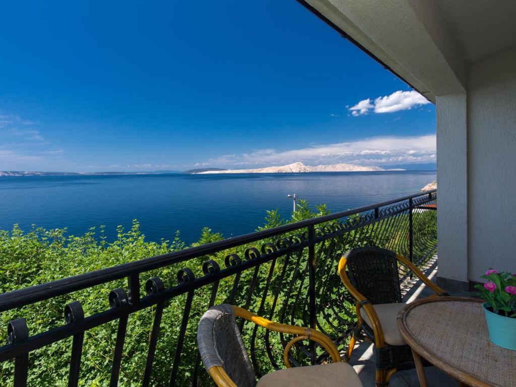 a balcony with chairs and a view of the water at Apartment Starigrad-4 by Interhome in Starigrad