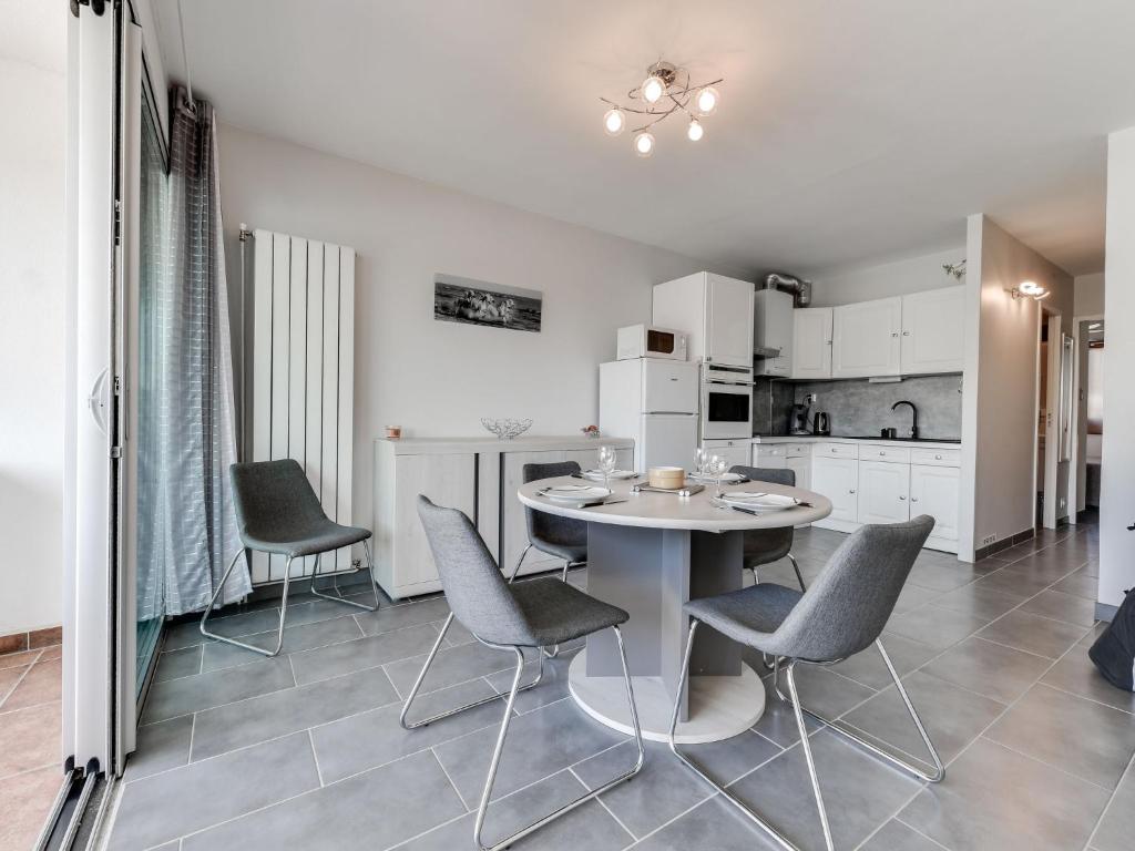 a kitchen and dining room with a table and chairs at Apartment Les Marinas de la Plage I-3 by Interhome in Le Grau-du-Roi