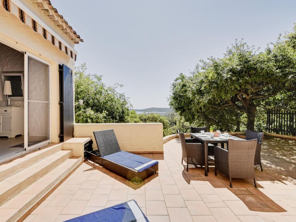 a patio with a table and chairs and a view at Apartment Village de Silhouette-3 by Interhome in Grimaud