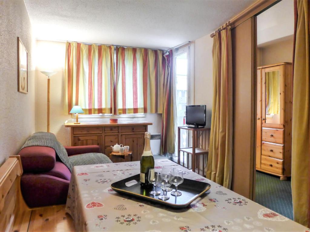 a hotel room with a bottle of wine on a table at Apartment Jonquilles-10 by Interhome in Chamonix