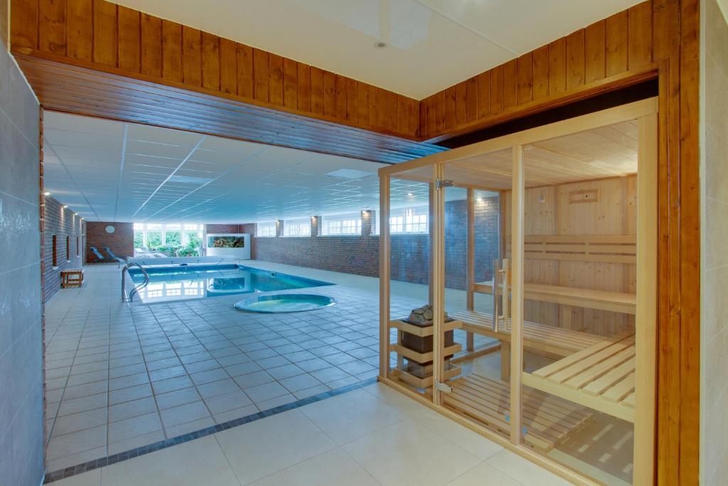 a large room with a swimming pool in a house at Balgavies Home Farm - Cottage in Forfar