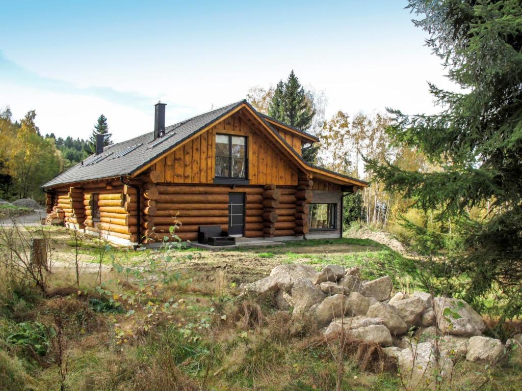 a log cabin in the middle of a field at Chalet Srub Kuří by Interhome in Benešov nad Černou