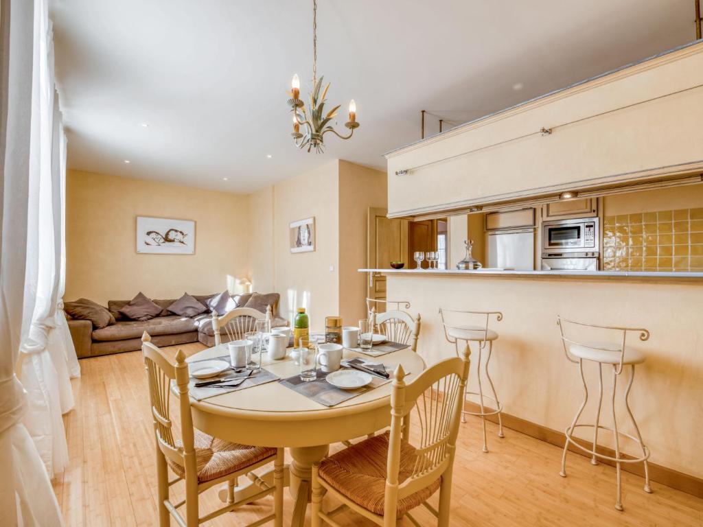 a kitchen and living room with a table and chairs at Apartment Boulevard Louis Blanc-1 by Interhome in Saint-Tropez