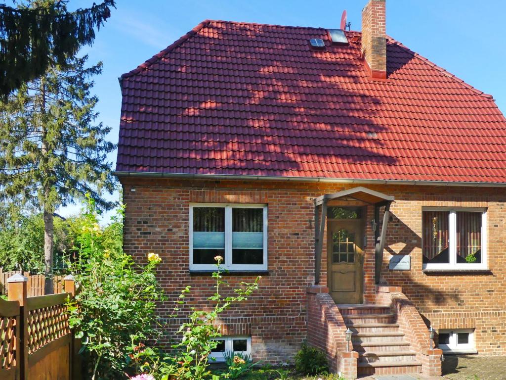 a brick house with a red roof at Holiday Home Landhaus Inselsee by Interhome in Mühl Rosin