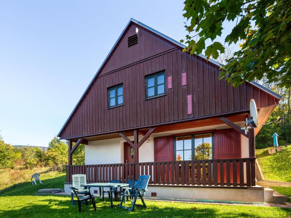 a house with a table and chairs in front of it at Holiday Home Holiday Hill 35 by Interhome in Lauterwasser