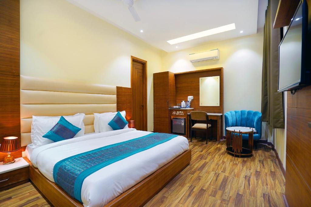 a hotel room with a bed and a desk at Hotel Aura Grand By Levelup Hotels in Amritsar