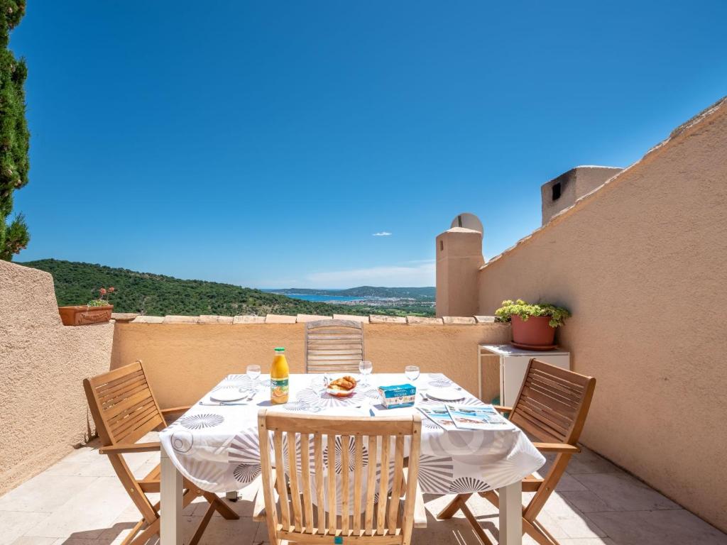 a table and chairs sitting on a patio at Apartment Village de Silhouette-5 by Interhome in Grimaud