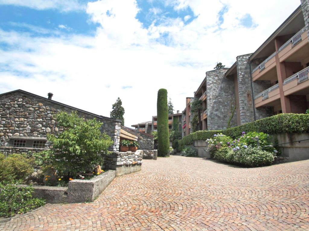 a brick walkway in front of a building at Apartment Hermitage-19 by Interhome in Porto Valtravaglia