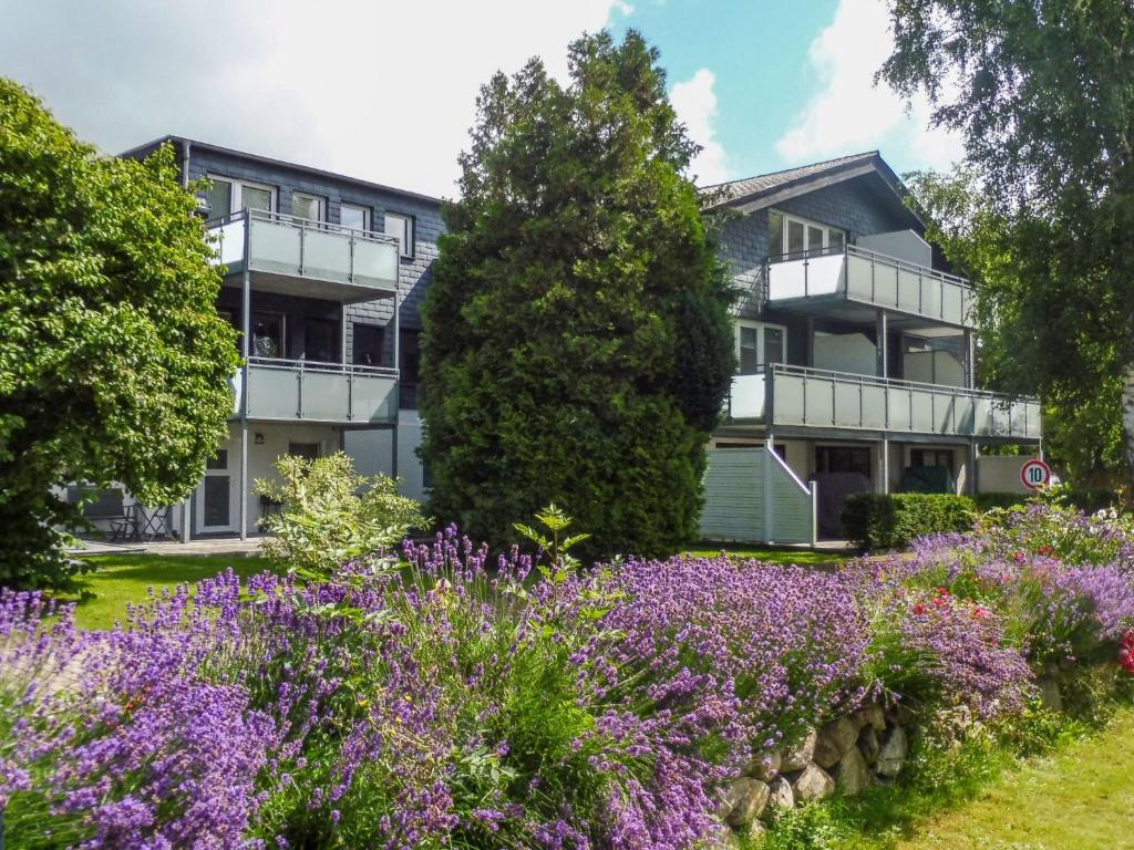 an apartment building with purple flowers in front of it at Apartment Sturm by Interhome in Warwerort