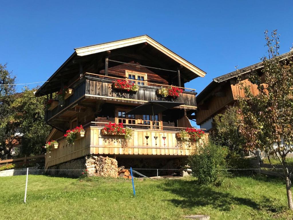 a large wooden house with flower boxes on the balcony at Chalet Feldkasten by Interhome in Dorf