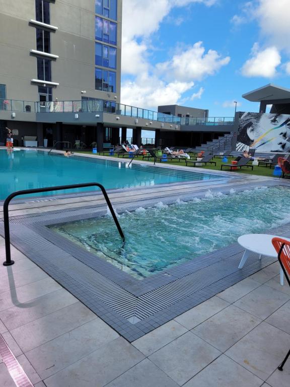 a large swimming pool with a rail in a building at Lovely Condo Unit in Miami