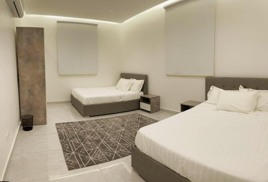 a hotel room with two beds and azeb sidx sidx sidx sidx sidx at فيلا الجبل in Al Hada