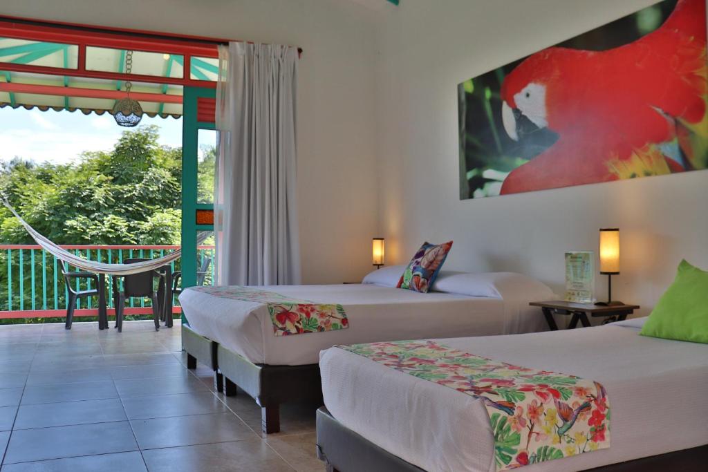 Postel nebo postele na pokoji v ubytování Hotel Campestre La Tata