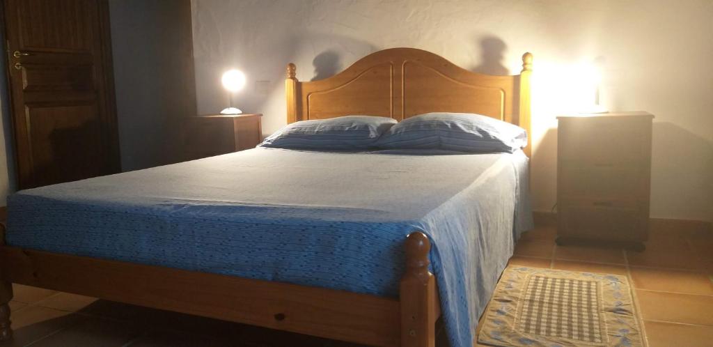 
a bedroom with a bed and a lamp at Captivating 2-Bed Apartment in Iglesias sailing in Iglesias
