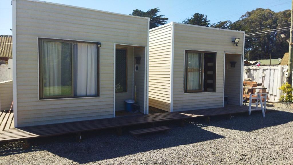 a tiny house sitting on top of a gravel lot at Cabañas MI REFUGIO in Isla Negra