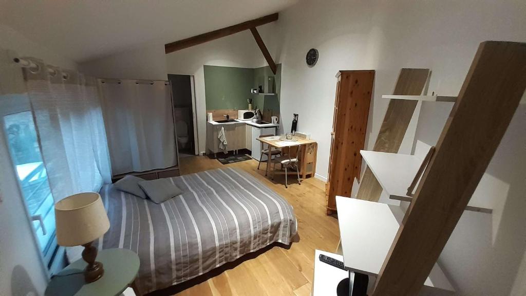 um pequeno quarto com uma cama e uma secretária em La Bulle em Châlons-en-Champagne